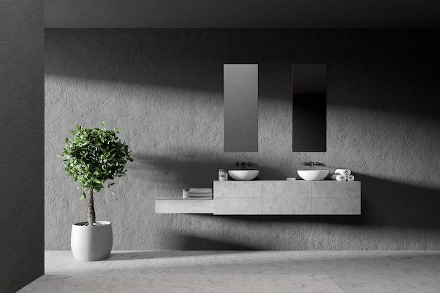 Meuble vasque suspendu dans une salle de bains au style minimaliste avec des finitions en pierre, idéal pour un projet richardson sanitaire chauffage plomberie carrelage photovoltaïque.