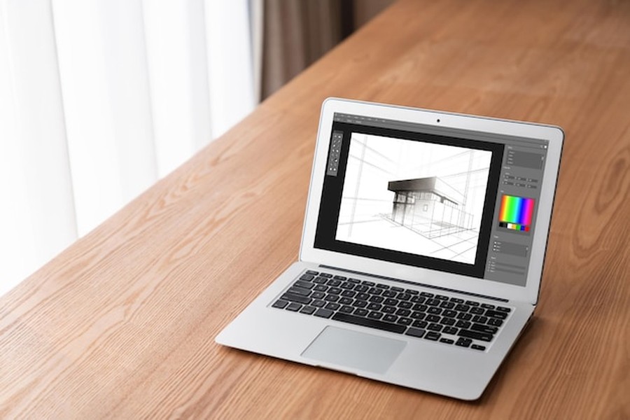 Ordinateur portable sur un bureau en bois affichant un logiciel gratuit aménagement intérieur avec un plan 3D architectural.